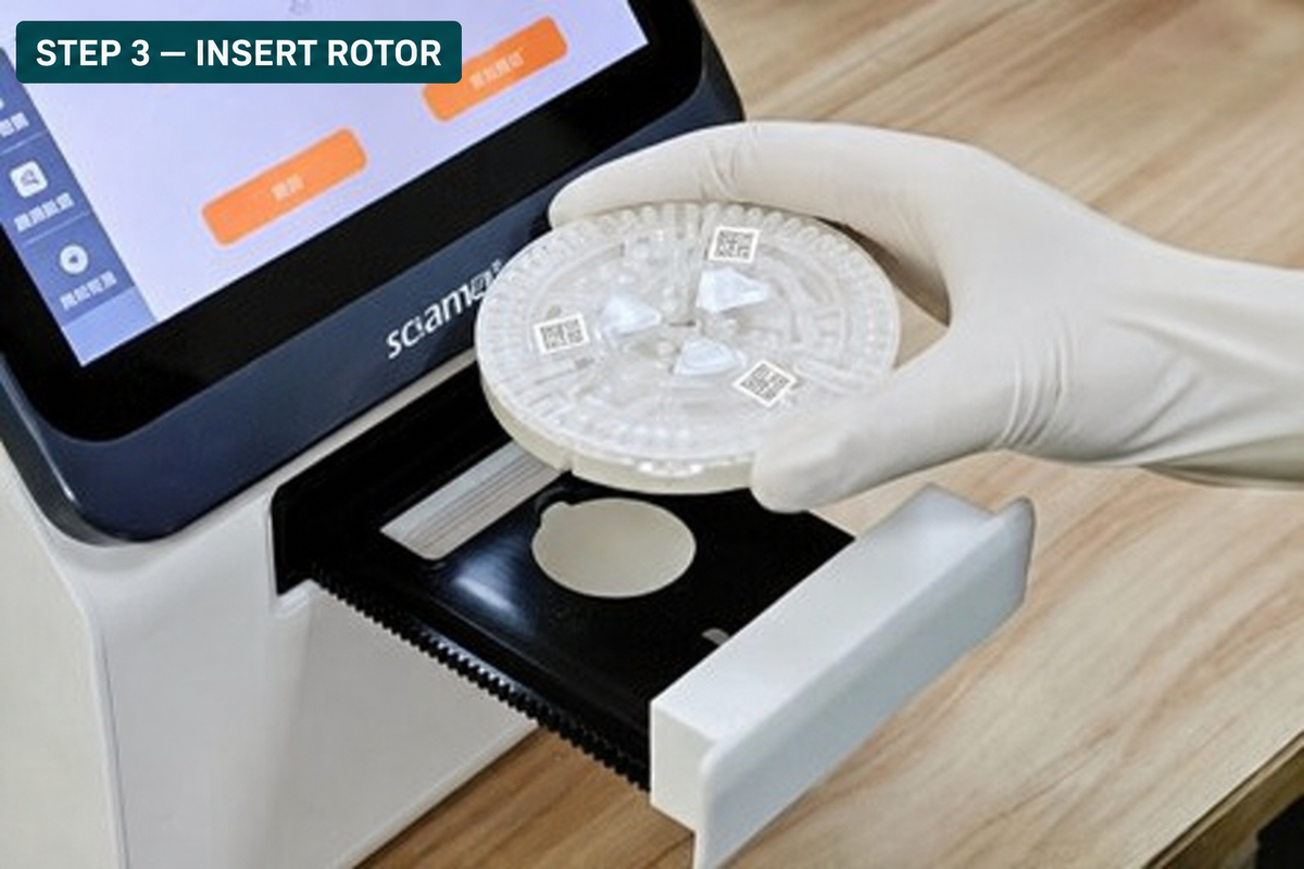 Insert rotor into tray of ClinixLynx Qt3 Biochemistry Analyzer - A close-up of a gloved hand inserting a circular clear sample rotor into the drawer of a Qt3 with a screen and text overlay reading 'STEP 3 - INSERT ROTOR'.